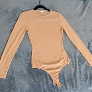 Neutral ribbed thong bodysuit by Gianni Bini